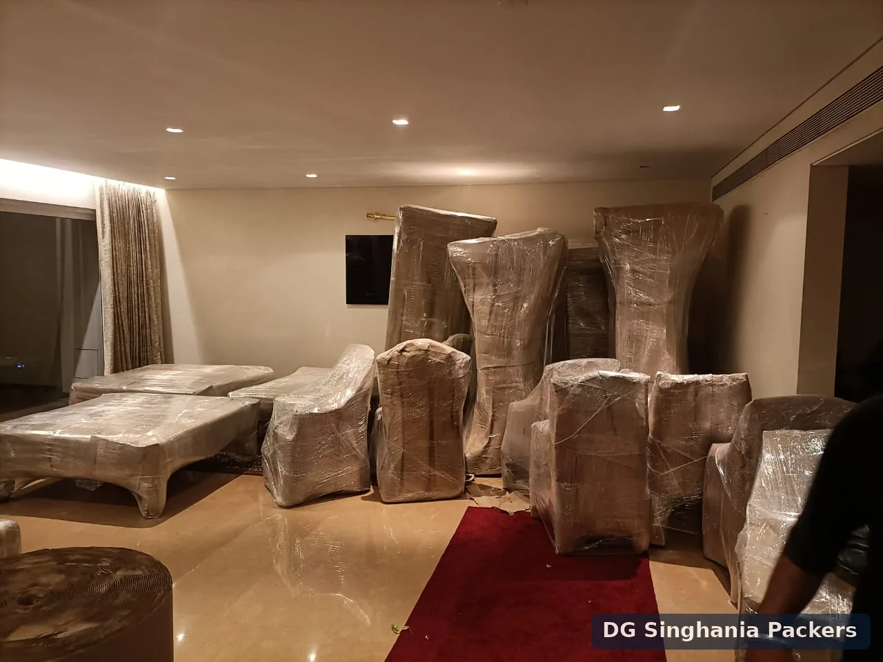 Household furniture securely wrapped for an intercity move from Pune