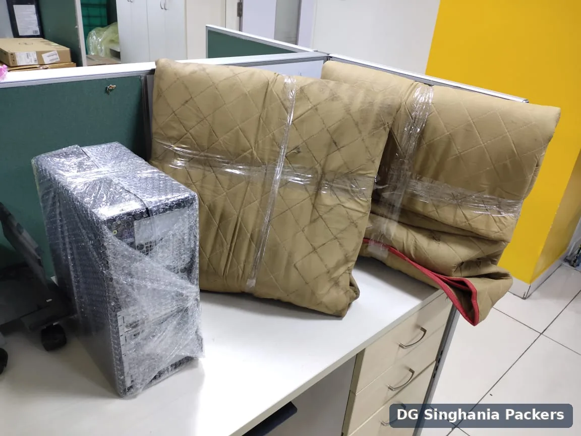 Computer equipment and office chair parts packed for office shifting in Pune