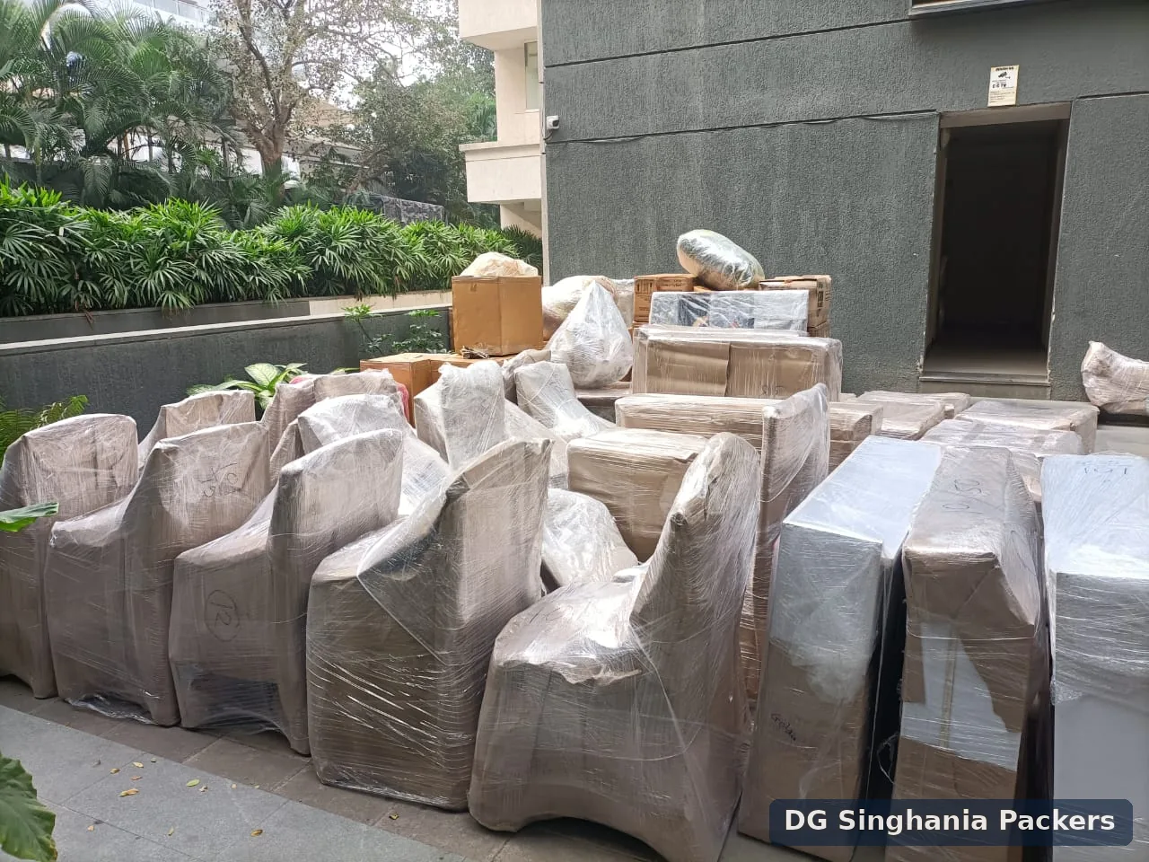 Packed household furniture arranged outside a residential building in Pune